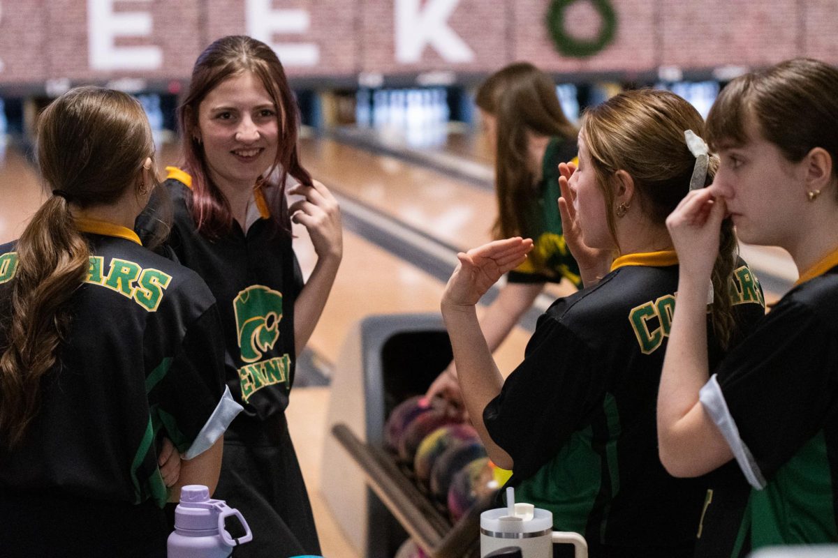 The Kennedy girls bowling team provides feedback to junior Kiera Foye after her previous throw. The team encourages her and gives tips for future throws. 