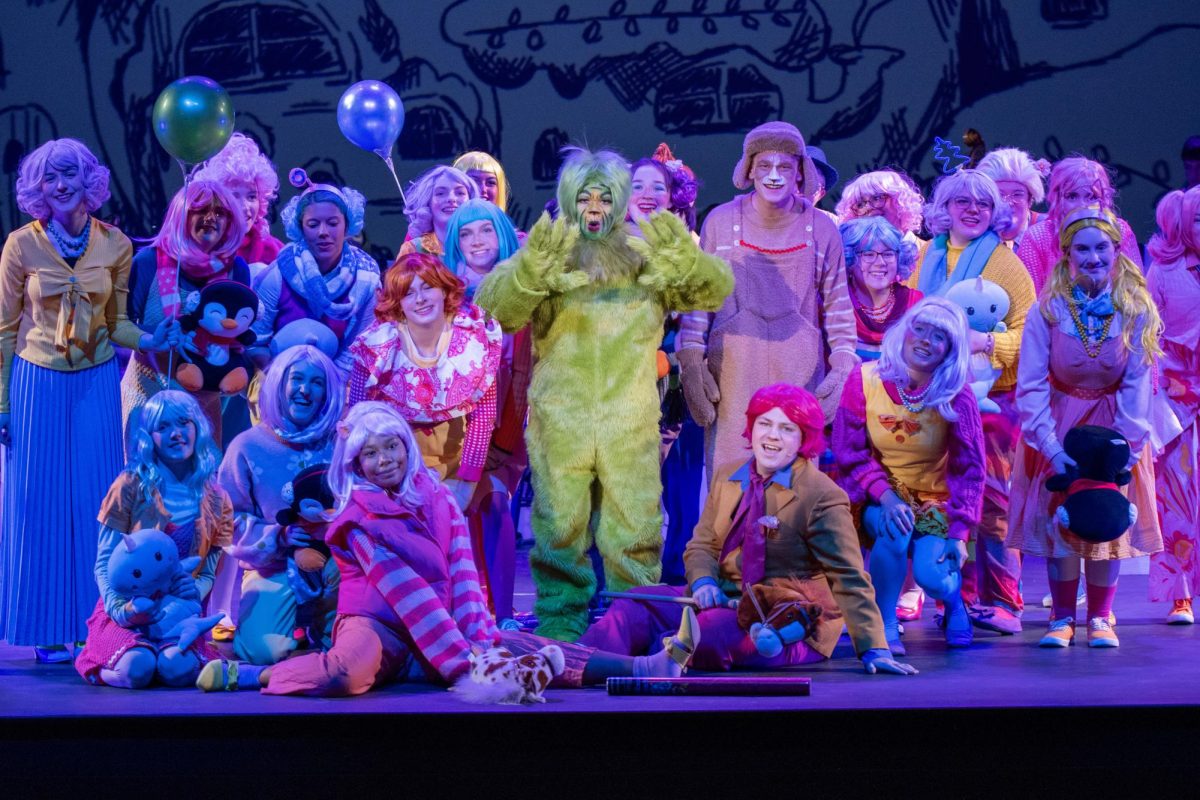 The Grinch, played by Izzy Westercamp, is surrounded by colour. The Christmas-themed show had sold out for the first time in Kennedy history.