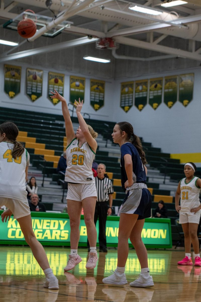 Attempting the free throw, junior Mia Huber shoots the ball towards the hoop.