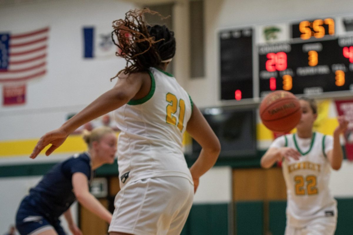 Passing the ball, sophomore Jaedynn Pledge throws the ball to freshman Emayah Smith.