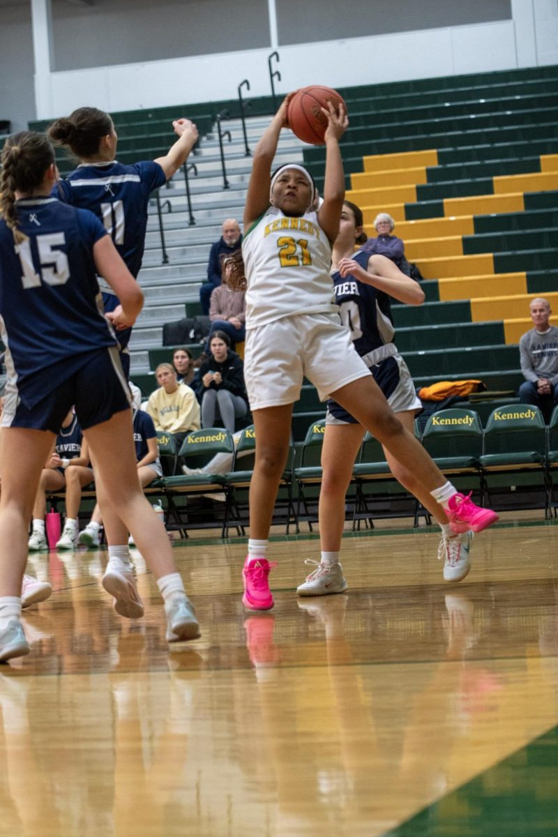 Jumping for the catch, freshman Emayah Smith catches the ball.