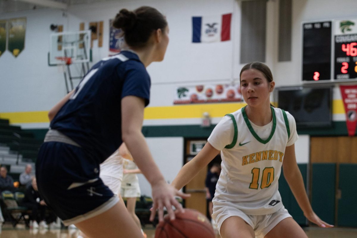 Not letting the player get past her, sophomore Katelyn Moser guards the path to the hoop.