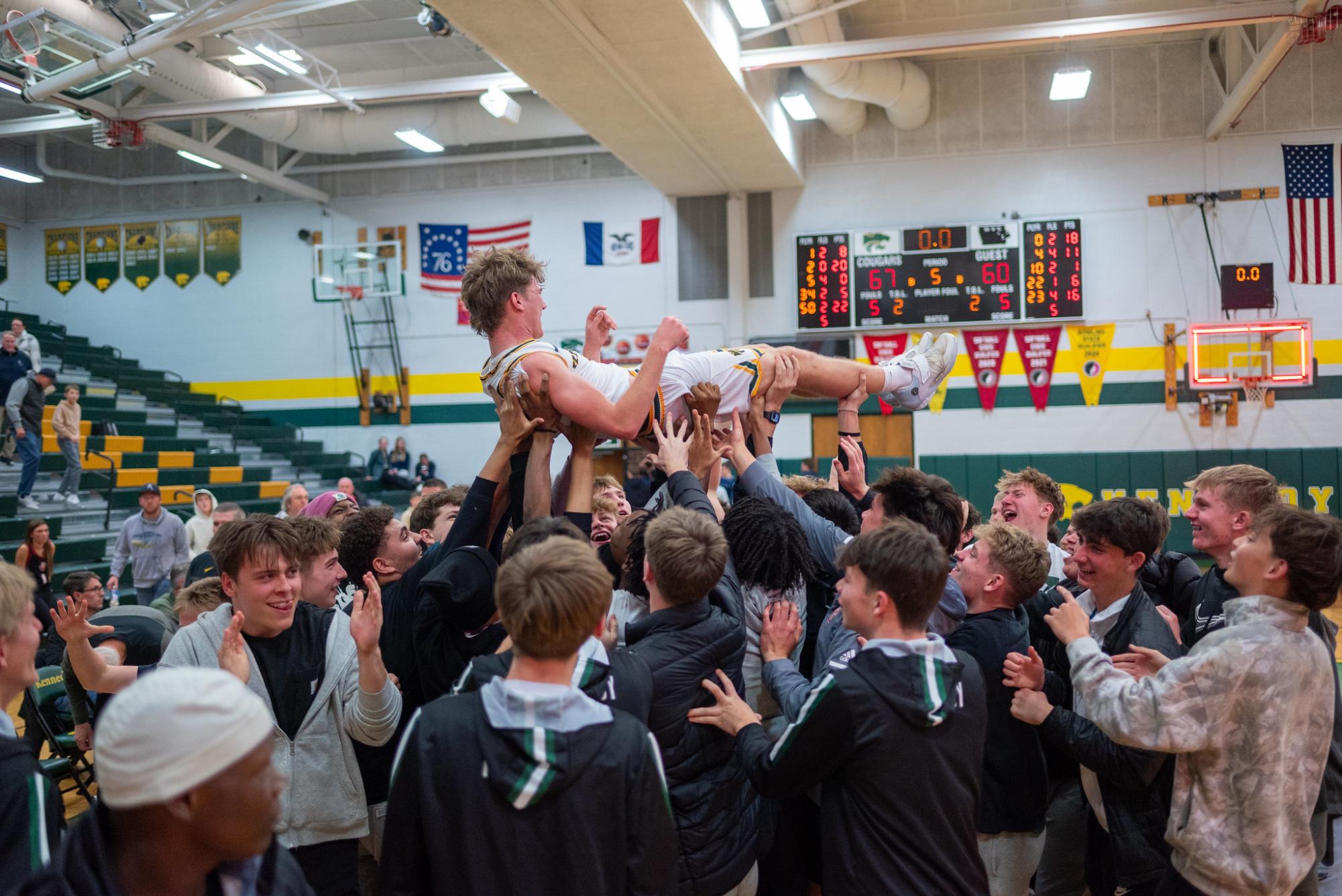 Carrying him off of the court after the game, the Kennedy student section celebrates junior Lawson Neighbor's career high game. Neighbor ended with 22 points off of 8/11 FG shooting and 4/4 from the three point line.