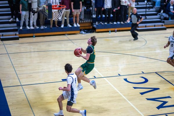 Elevating for the acrobatic layup, junior Lawson Neighbor connects for his sixth layup of the game. Neighbor ended the game with 16 points off of a perfect 100% shooting.