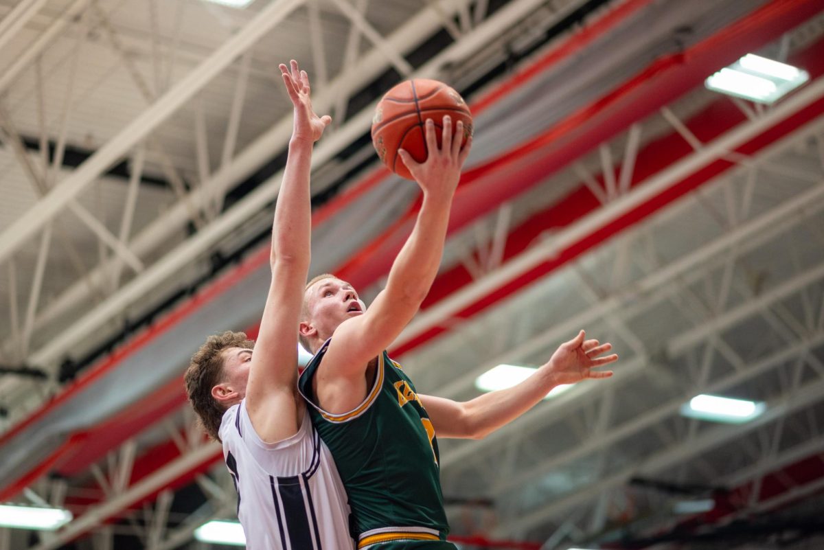 Absorbing the contact, freshman Drew McKowen gets the tough layup to fall.