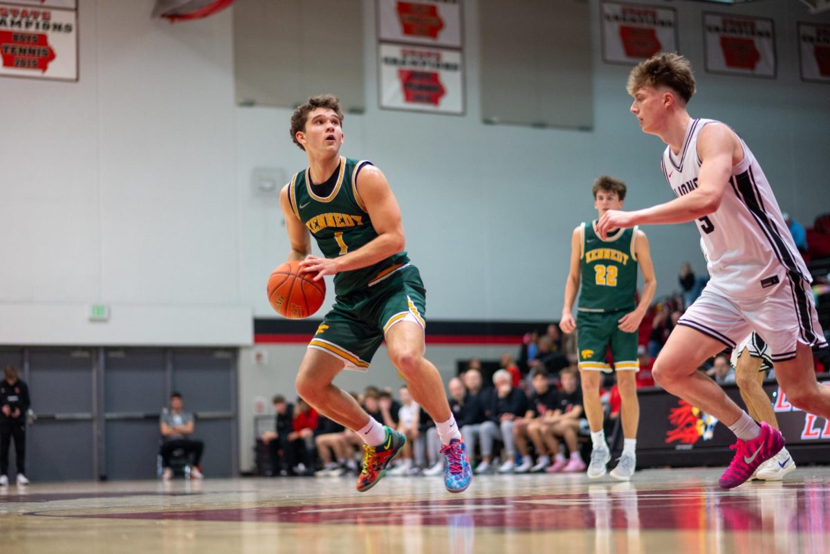 Setting his feet for a mid range shot, junior Jaxson Bean looks to get away from Linn Mar defender Tyler Hilton. Bean ended with 25 points on a season high game. 