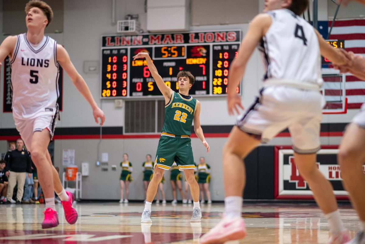 Holding his follow through, senior Justin Powell watches his  three point shot go. 