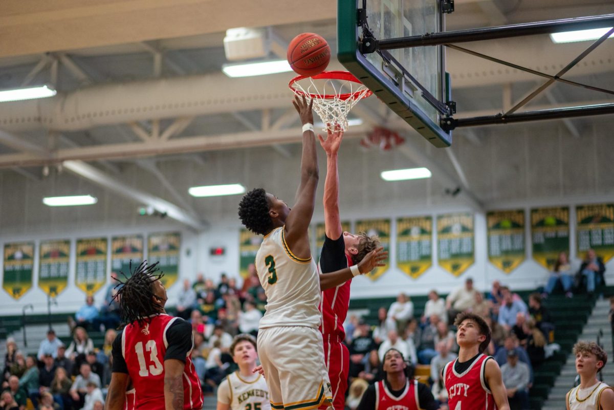 Going up with the City High defender, senior Thierry Boyd scores a layup through the contact