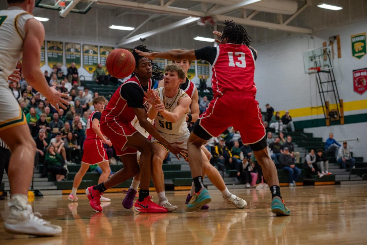 Looking to get out of the trap, junior Lawson Neighbor passes the ball to teammate Deacon Kucera.