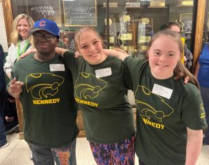 Antonio Long, Brooklyn Perez, and Ashlyn Presley smile before showcasing their basketball skills at the Special Olympics on Mar. 14.